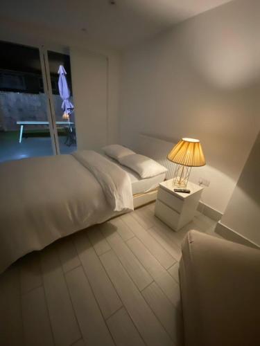 a bedroom with a bed and a table with a lamp at Blue House in Stone Grove