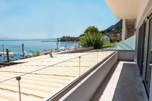 a balcony with a view of the water at Blue Sea Benitses - Beachfront Apartment in Benitses