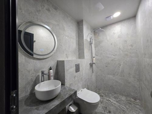 a bathroom with a sink and a toilet and a mirror at Villa Cadaques in Lozenets