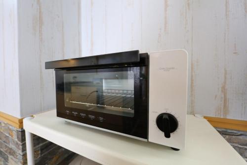 a microwave sitting on top of a white table at Prosper 6th bldg in Nagoya