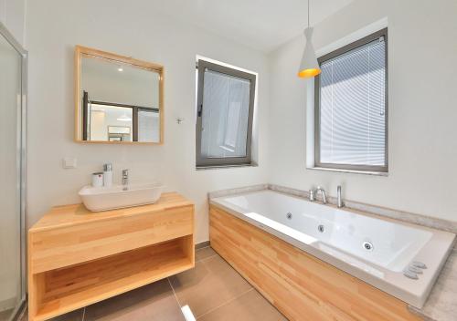 a bathroom with a tub and a sink and a mirror at Villa Serenity in Kas
