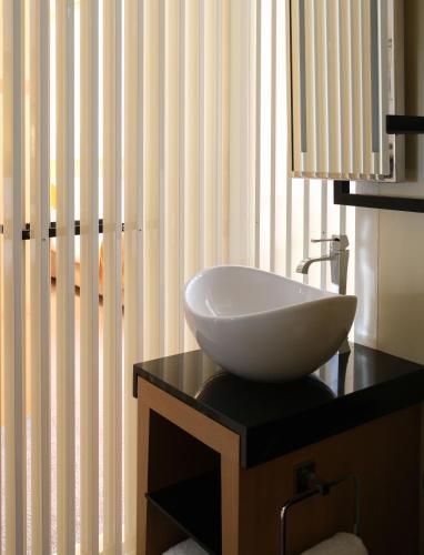 a white sink on a black counter in a bathroom at Five Seas Cannes, a Member of Design Hotels™ in Cannes