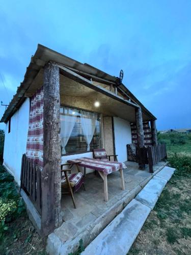 a small house with a picnic table in front of it at Honey home in Chʼkalovka