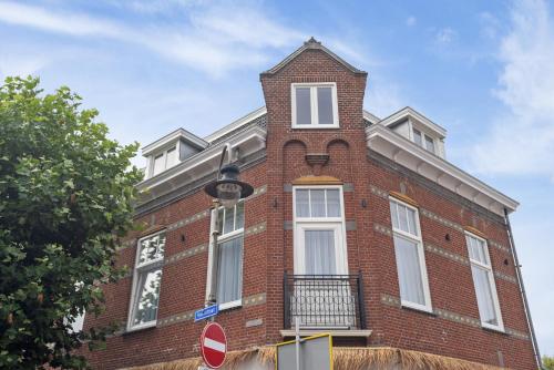 a red brick building with a clock tower on it at Boutique hotel Novi in Zandvoort