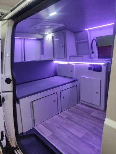 an empty room with purple lighting in an rv at Autocaravana Camper in Las Palmas de Gran Canaria