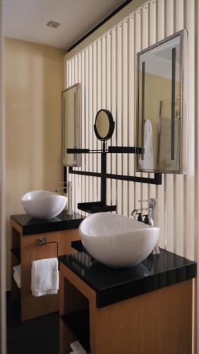 a bathroom with two sinks and a mirror at Five Seas Cannes, a Member of Design Hotels™ in Cannes