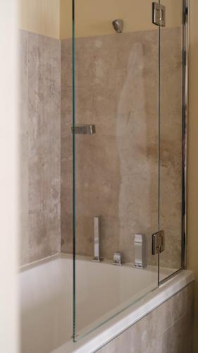 a shower with a glass door in a bathroom at Five Seas Cannes, a Member of Design Hotels™ in Cannes