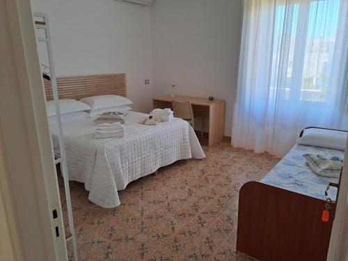 a bedroom with a bed with a ladder and a window at San Michele Apartment in Bari