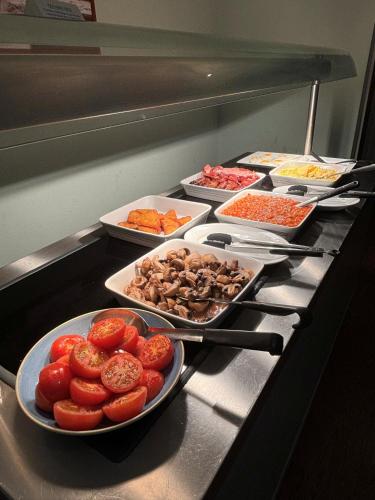 a buffet with many plates of food on a counter at The Beeches Hotel & Leisure Club in Nottingham