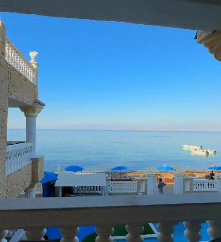 a view of the ocean from the balcony of a resort at Lucky palace Dahab in Dahab
