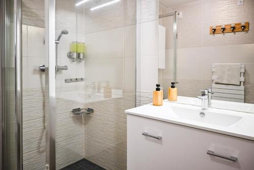 a bathroom with a sink and a shower at Le Golden - Centre Ville - Accès Transports en Commun - Balcon Cosy - Commerces à Proximité in Schiltigheim