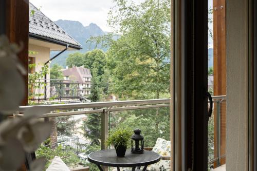 a view from a window of a balcony with a table at Aqua Park Residence VIPAPARTAMENTY in Zakopane