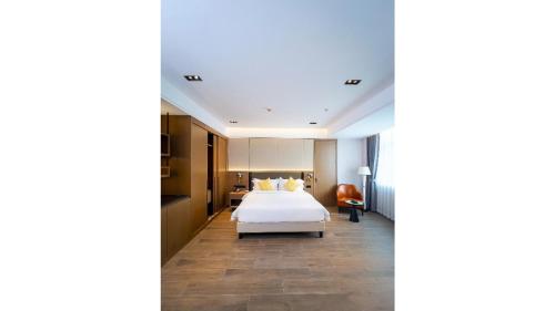 a hotel room with a bed in the middle at Golden Tulip Kin-Oasis Kinshasa in Kinshasa