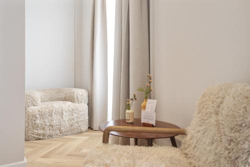 a living room with a chair and a table at Boutique hotel Novi in Zandvoort