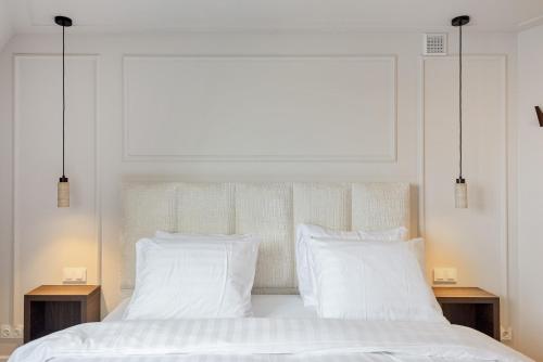 a bedroom with two white pillows and a bed at Boutique hotel Novi in Zandvoort