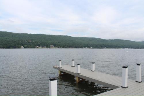 a dock in the middle of a body of water at Lakefront Haven on Greenwood Lake in Hewitt