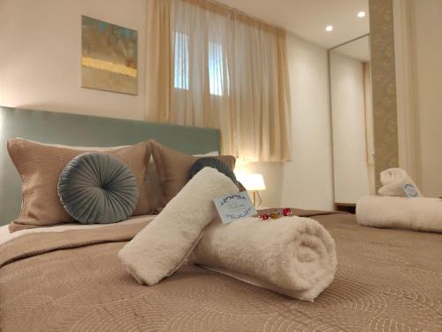 a bedroom with a bed with a towel animal on it at CORFU TENNIS Studios in Agios Rokkos
