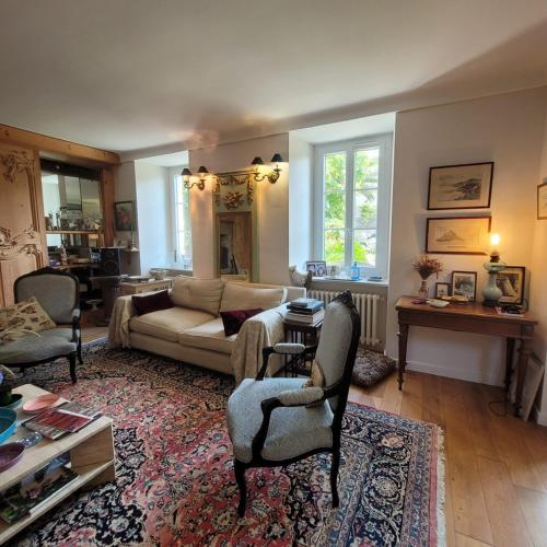 a living room with a couch and a table at Chambres d'Hôtes Maison de Charme à Trégastel in Trégastel