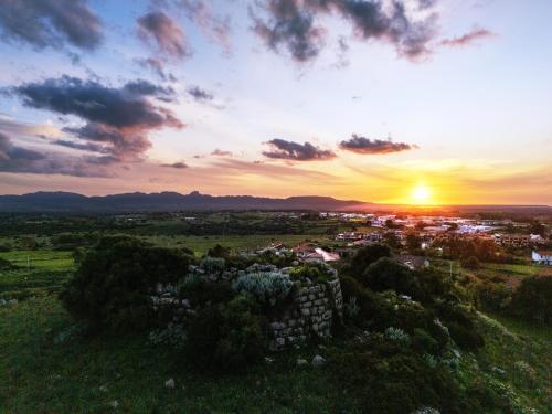 a sunset over a small town in a field at "Da Remo" in Mògoro