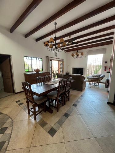 a dining room and living room with a table and chairs at Casa en Victoria Entre Rios - Casa Rocamora in Victoria