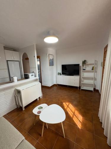 a living room with a couch and a table at Apartamento Oasis Alamillo in Puerto de Mazarrón