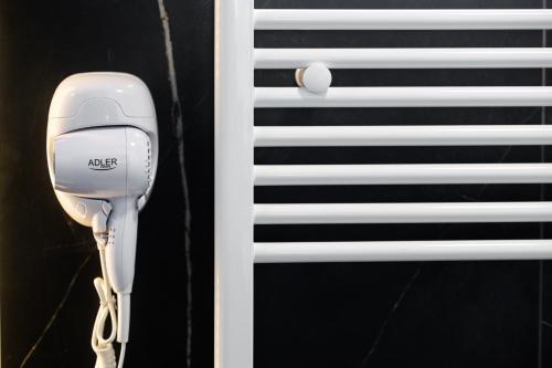 a hairdryer hanging next to a window at Nest Suites in Skopje
