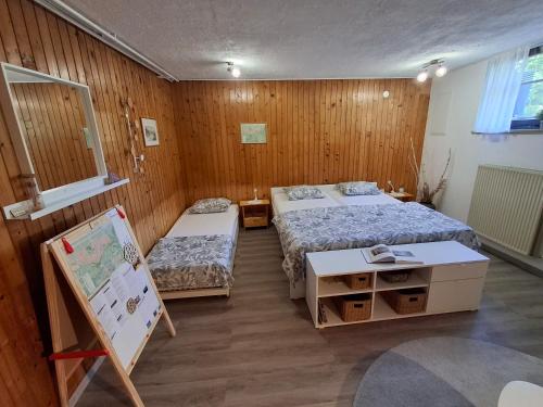 a room with two beds and a painting in it at Prenočišče Breza in Radovljica