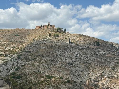 a castle on the top of a hill at Apartamentos BocairentHomes, en pleno centro de Bocairent, con pequeña piscina y parking privado in Bocairent
