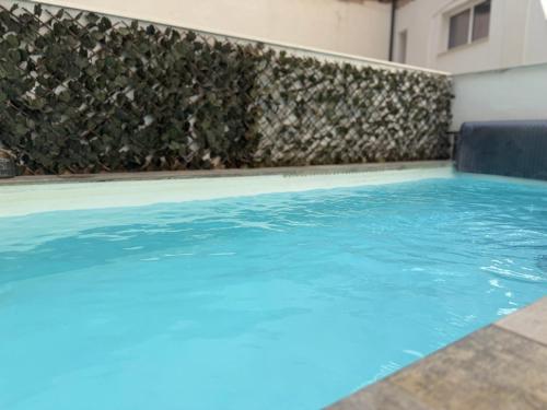 a swimming pool with blue water in a building at Apartamentos BocairentHomes, en pleno centro de Bocairent, con pequeña piscina y parking privado in Bocairent