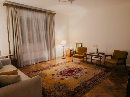 a living room with a couch and a table and chairs at Casa RusTic in Turda