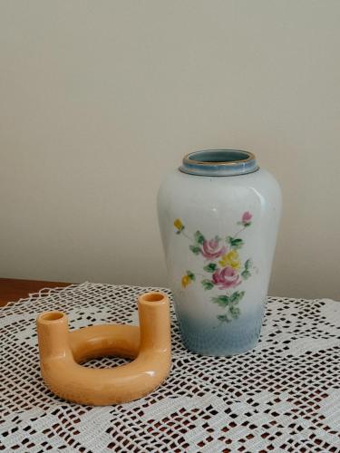 a vase sitting on a table next to a wooden handle at Casa RusTic in Turda