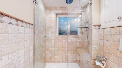 a bathroom with a shower with a toilet and a window at Uep Soel in Kampen