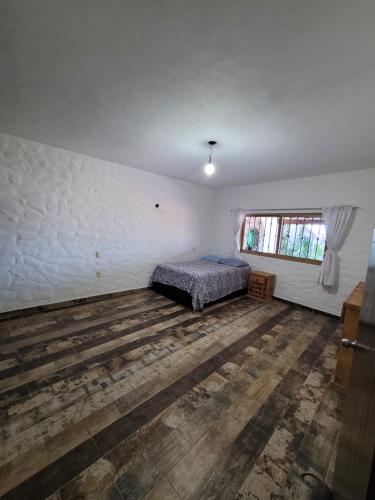 Ένα ή περισσότερα κρεβάτια σε δωμάτιο στο Casa Grande con Alberca en San Gaspar