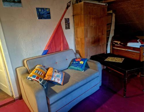 a living room with a couch with pillows on it at Puķkalniñš in Ventspils