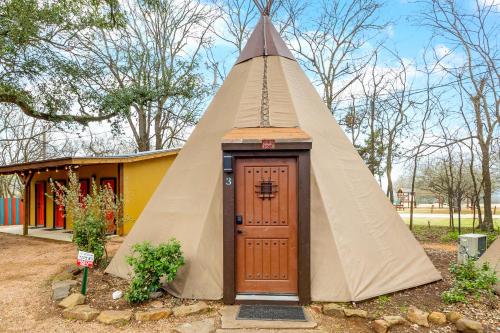 a teepee house with a door in front of it at Tipis on the Guadalupe in New Braunfels