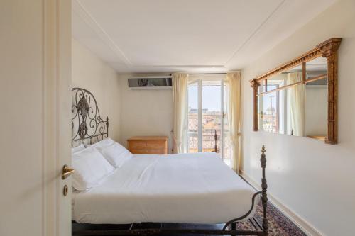 a bedroom with a white bed and a window at Celeste Retreat al Pantheon - Homkeey Apartments in Rome