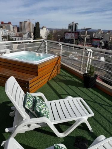 a balcony with a hot tub and a chair on a cruise ship at Hotel Libertad in Villa Carlos Paz