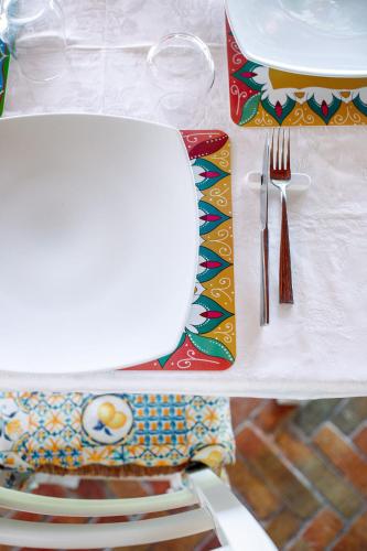 a table with a plate and a fork and knife at Limora' Tenuta Millaci in Mazzarino