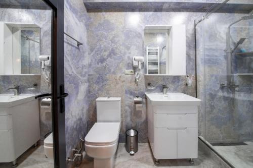 a bathroom with a toilet and a sink and a shower at Kera Ethno Hotel in Gvishtibi