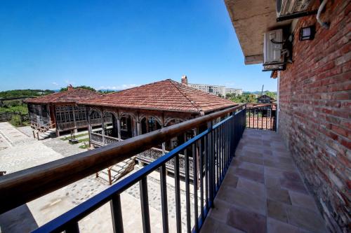 a balcony of a building with a brick wall at Kera Ethno Hotel in Gvishtibi
