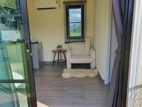 a living room with a chair and a window at Nordika Hill in Pak Chong