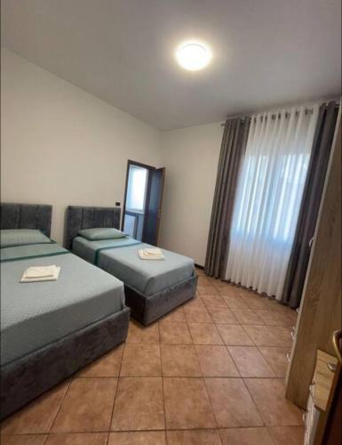 a room with two beds and a window at KapaCasa in Villanova