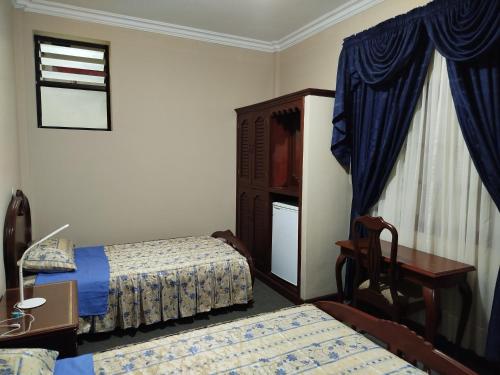 Ένα ή περισσότερα κρεβάτια σε δωμάτιο στο Hotel Perez