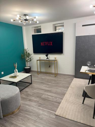 a living room with ametix sign on the wall at La Suite Genève Gaillard - Jacuzzi Privé & Séjour Luxe in Gaillard