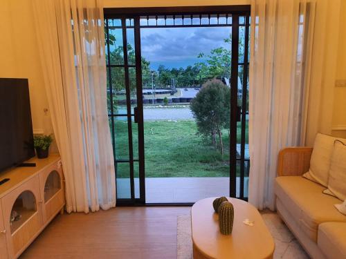 a living room with a large sliding glass door at Nordika Hill in Pak Chong