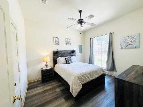 a bedroom with a bed and a ceiling fan at Chateau 11 in Hammond