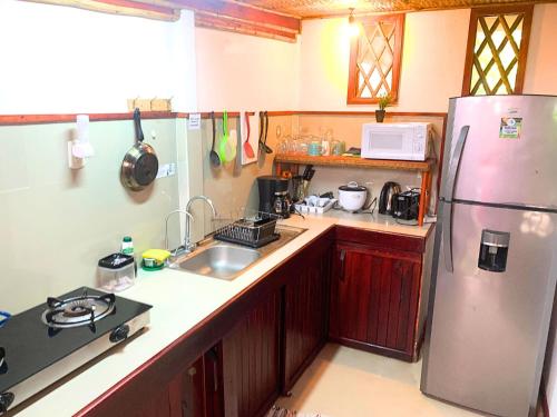 a kitchen with a refrigerator and a sink at Villa 6 - Luxury 2 Bed Villa - Small Private Garden in Cocles