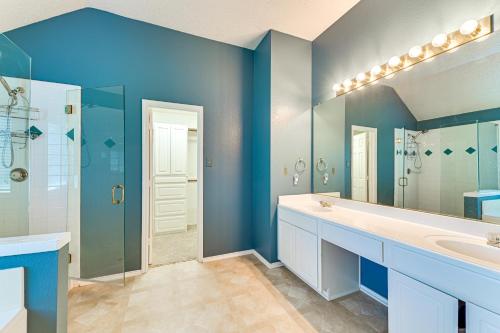 une salle de bain bleue avec deux lavabos et une douche dans l'établissement DFW Sports Hub Home with Pool and Hot Tub in Frisco!, à Frisco