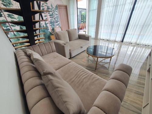 a living room with a couch and a table at Nordika Hill in Pak Chong
