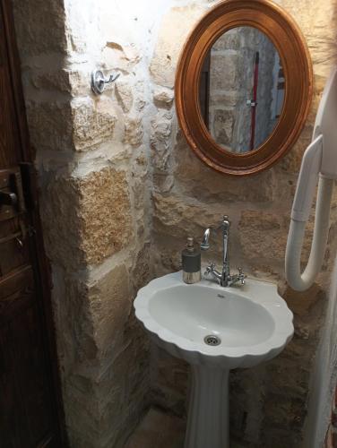 a bathroom with a white sink and a mirror at Villa Agapi 2 in Kamilari